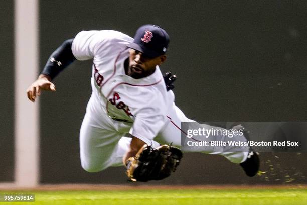 Jackie Bradley Jr. #19 of the Boston Red Sox dives as he makes a catch during the fifth inning of a game against the Texas Rangers on July 10, 2018...