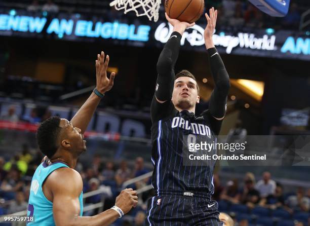 The Orlando Magic's Mario Hezonja shoots against the Charlotte Magic's Dwight Howard at the Amway Center in Orlando, Fla., on April 6, 2018.