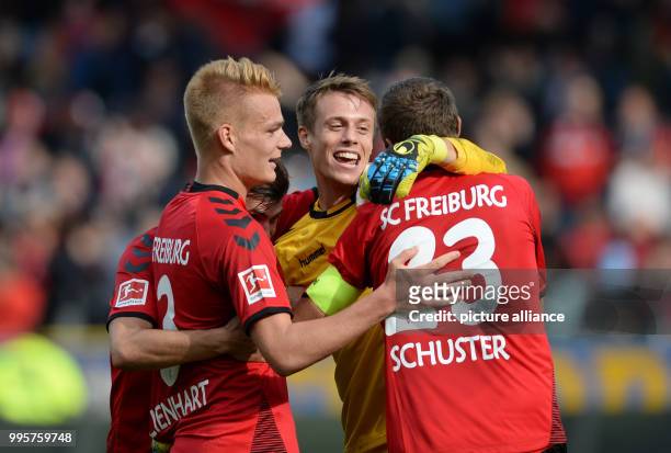 Philipp Lienhart, Pascal Stenzel, goalie Alexander Schwolow and Julian Schuster of Freiburg celebrate their 3:2 win in the German Bundesliga football...