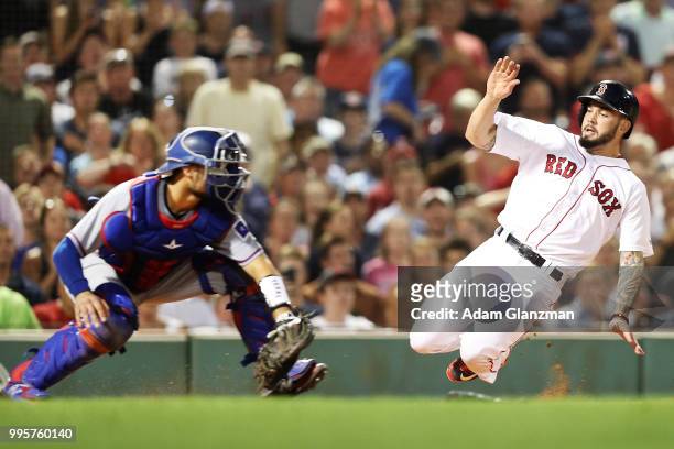 Blake Swihart of the Boston Red Sox slides safely into home past the tag of Isiah Kiner-Falefa of the Texas Rangers in the sixth inning of a game at...