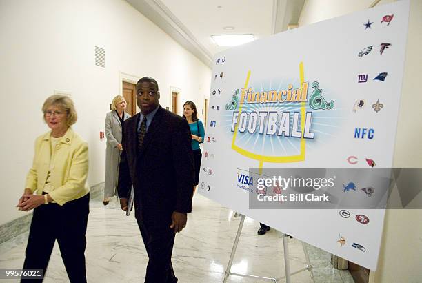 Rep. Judy Biggert, R-Ill., arrives with former Washington Redskins All-Pro player Darrell Green for the kick-off event for the 2006 season of...