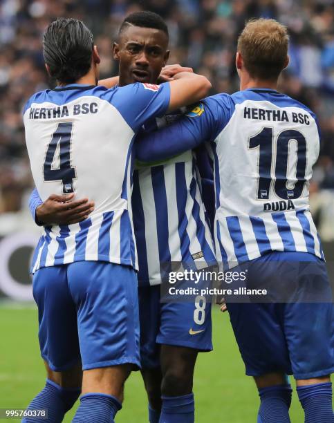 Hertha's Salomon Kalou celebrates after his goal at 2:2 with Karim Rekik and Ondrej Duda during the German Bundesliga football match between Hertha...