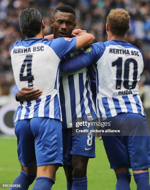 Hertha's Salomon Kalou celebrates with team mates Karim Rekik and Ondrej Duda after scoring 2-2 during the German Bundesliga soccer match between...