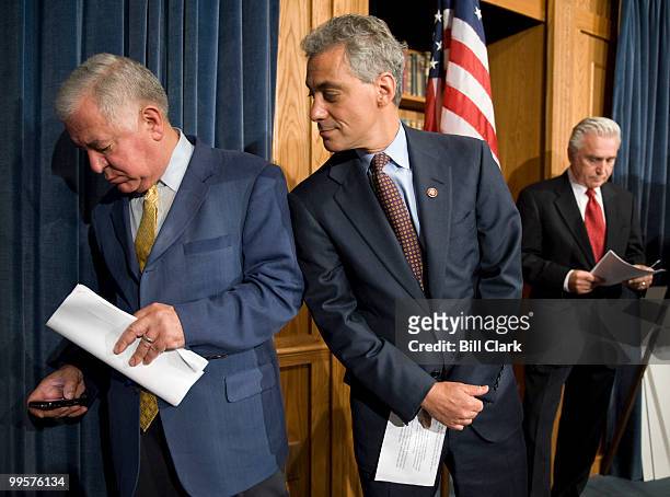 Rep. Nick Rahall, D- W.Va., tries to silence the speaker phone feature on his Blackberry as Rep. Rahm Emanuel, D-Ill., watches during the Democrats'...
