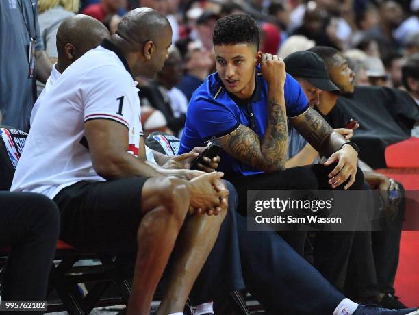 Kyle Kuzma of the Los Angeles Lakers talks with Los Angeles Lakers president of basketball operations Earvin 'Magic' Johnson during the 2018 NBA...