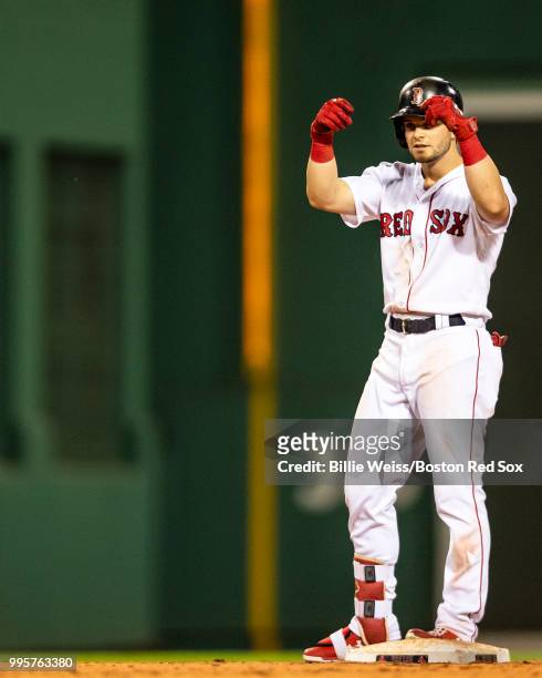 Andrew Benintendi of the Boston Red Sox reacts after hitting an RBI double during the seventh inning of a game against the Texas Rangers on July 10,...