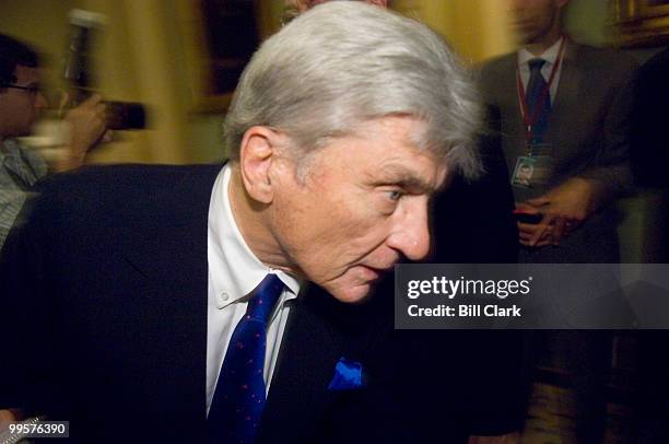 Sen. John Warner, R-Va., ducks into the Republican Policy luncheon as a crush of reporters and photographers following Sen. John McCain approaches in...