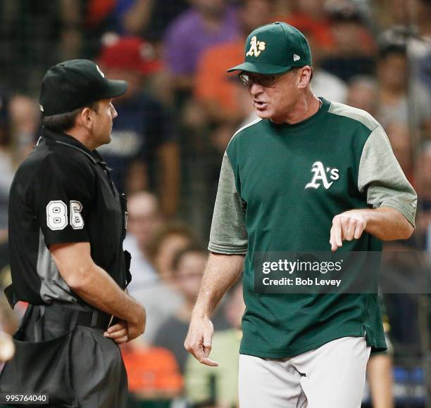 Bob Melvin of the Oakland Athletics argues with home plate umpire David Rackley after he was ejected for questioning a called strike three on Khris...