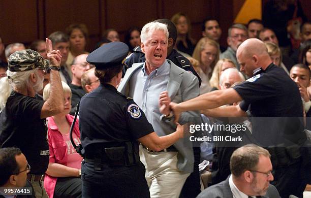 Protester is removed form the hearing room after shouting anti-war statements as Armed Forces Commander in Iraq Gen. David Petraeus and U.S....