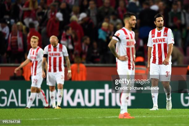 Cologne's Tim Handwerker , Konstantin Rausch, Leonardo Bittencourt and Claudio Pizarro stand defeated after German Bundesliga match between 1. FC...