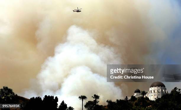 Smoke billows from a brush fire in Griffith Park near Griffith Observatory on July 10, 2018 in Los Angeles, California.