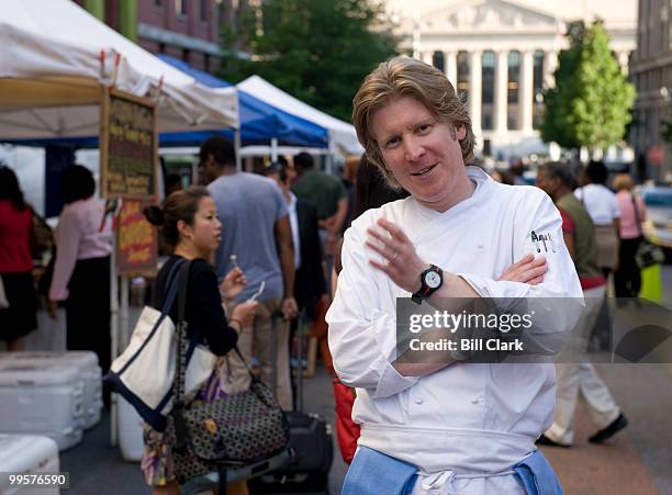 Robert Weland, executive chef at Poste Moderne Brasserie, talks to diners during a tour of the nearby Penn Quarter famers market before preparing a...