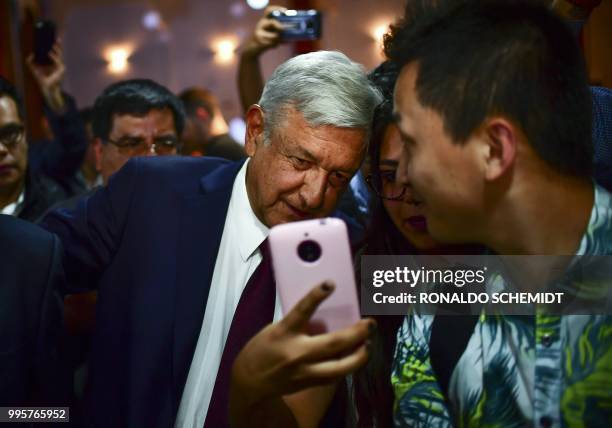 Mexico's President-elect Andres Manuel Lopez Obrador poses for a selfie with a supporter after a press conference in Mexico City, on July 5, 2018. -...