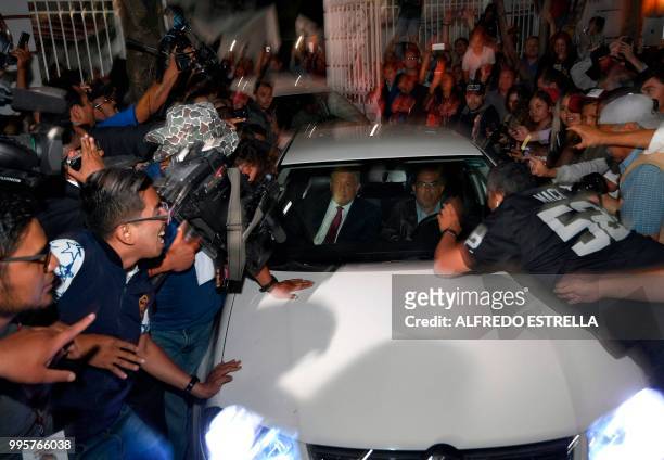 Mexico's President-elect Andres Manuel Lopez Obrador's car is surrounded by supporters and journalists after he won the elections, in Mexico City, on...