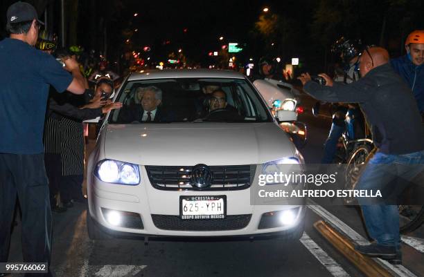 Mexico's President-elect Andres Manuel Lopez Obrador greets supporters from his car after winning the elections, in Mexico City, on July 1, 2018. -...