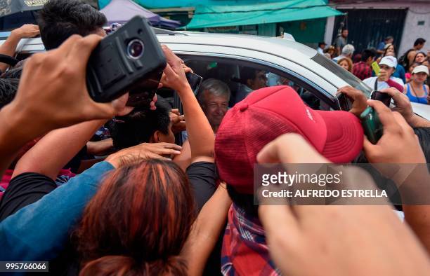 Supporters of then Mexican presidential candidate for the MORENA party, Andres Manuel Lopez Obrador , escort their candidate van after a campaign...