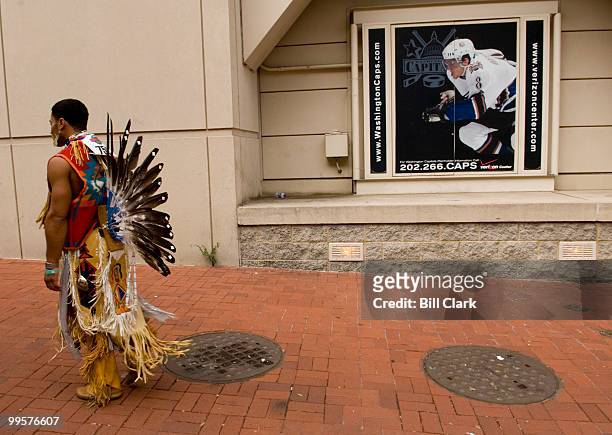 Dancing Eagle Frye, of the Wampanoag tribe of Cape Cod. Mass., walks outside of the Verizon Center in Washington as the National Powwow gets underway...