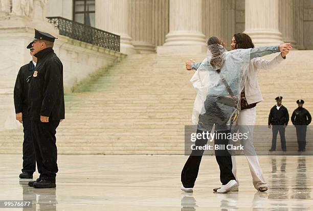 Makenzi Smith, of Norman, Okla., and Mallee McGee, of Midwest City, Okla., dance on the Supreme Court plaza in the rain on Wednesday, April 29 with...
