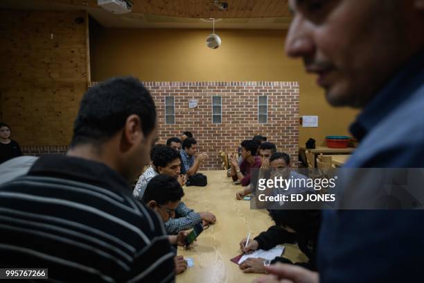 In a photo taken on July 4 Yemeni asylum seekers looking for accomodation write their names on a list during a gathering at the Olle Tourist Hotel in...