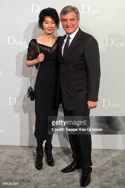 Dior president Sidney Toledano and actress Maggie Cheung pose for a photograph at the entrance of the Dior Cruise 2011 fashion show on May 15, 2010...