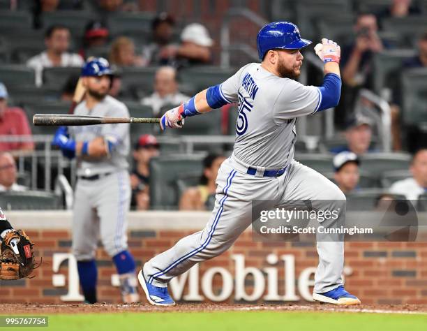 Russell Martin of the Toronto Blue Jays singles in the eighth inning to knock in a run against the Atlanta Braves at SunTrust Park on June 26, 2018...