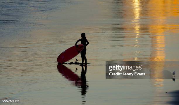 Surfers prepare to enter the water at Bondi Beach on July 11, 2018 in Sydney, Australia. Temperatures dropped to 7 degrees Celsius in Sydney this...