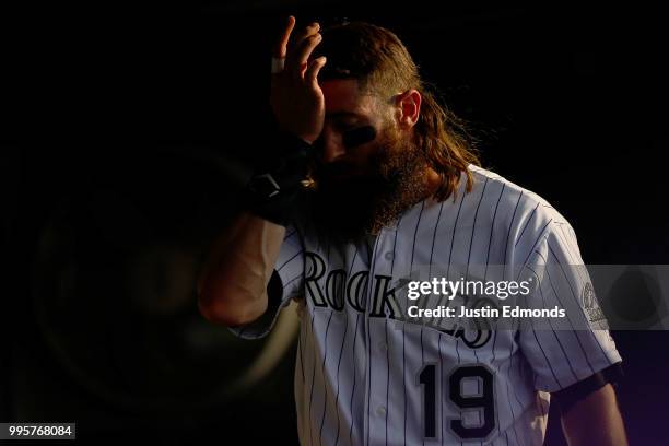 Charlie Blackmon of the Colorado Rockies wipes his brow on a sweltering evening during action against the Arizona Diamondbacks at Coors Field on July...