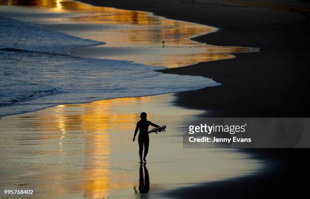 Surfers prepare to enter the water at Bondi Beach on July 11, 2018 in Sydney, Australia. Temperatures dropped to 7 degrees Celsius in Sydney this...