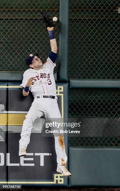 Kyle Tucker of the Houston Astros leaps at the wall but unable to make a catch at the wall on a fly ball by Marcus Semien of the Oakland Athletics in...