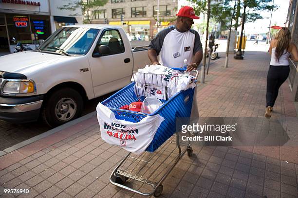 William McQueen, of Washington, sells McCain Palin t-shirts form a grocery cart outside of the Republican National Convention at the Xcel Center in...