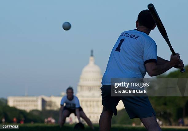 Jason Rauch, of Rep. Ike Skelton's office, takes his turn at bat during the Show Me Asses softball team practice on the National Mall on Monday,...
