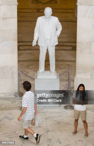 Tourists walk through the rotunda in the Russell Denate Office Building under the watchful eye of Sen. Richard Russell's statue on Monday, June 4,...