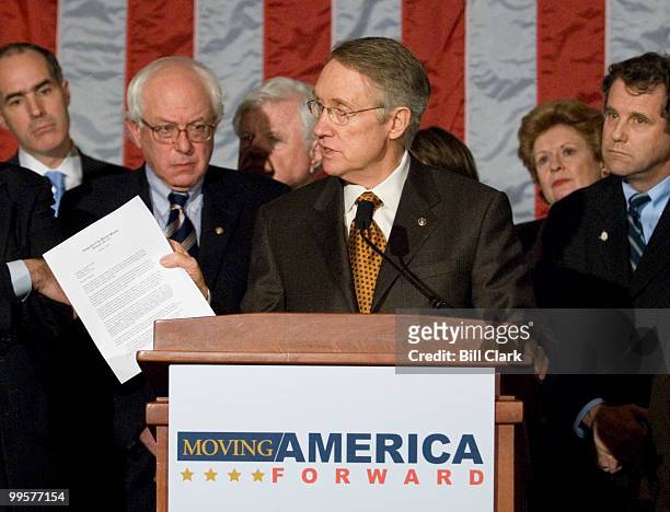 Senate Majority Leader Harry Reid, holding a copy of the Democrats' letter on Iraq sent to President Bush, speaks to the media as the Senate...