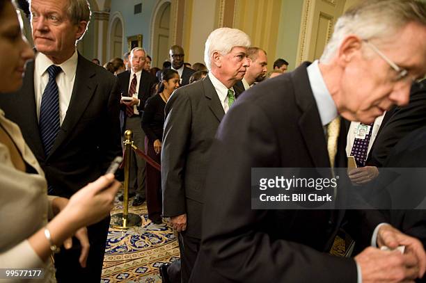 From left, Sen. Max Baucus, D-Mont., Sen. Chris Dodd, D-Conn., and Senate Majority Leader Harry Reid, D-Nev., scatter at the conclusion of their news...