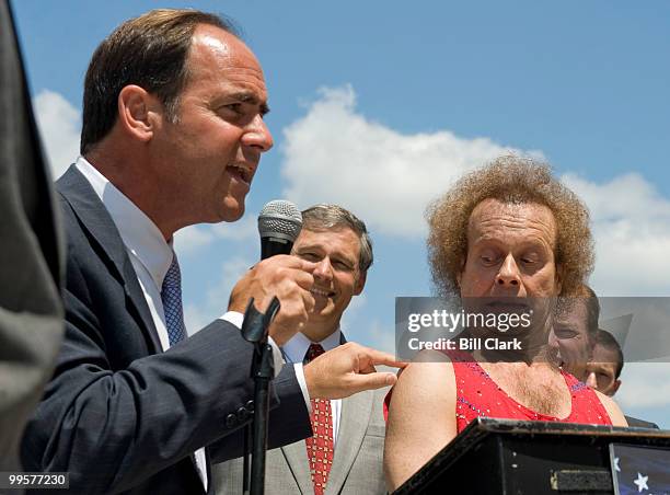 Richard Simmons reacts as Rep. Zach Wamp touches his shoulder during the "FIT Kids" rally to promote physical education in schools, following their...