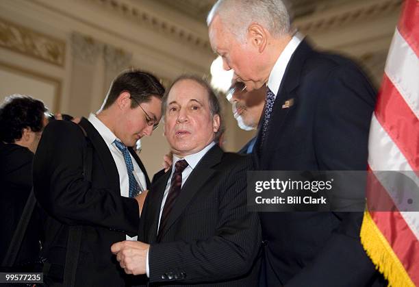 Singer-Songwriter Paul Simon speaks with Sen. Orrin Hatch, R-Utah, following the Families USA news conference to express support for the SCHIP...