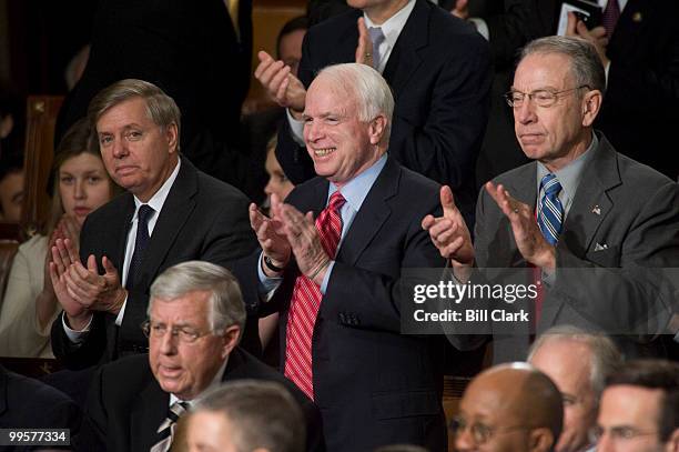 From left, Sen. Lindsey Graham, R-S.C., Sen. John McCain, R-Ariz., and Sen. Chuck Grassley, R-Iowa, applaud President Barack Obama as he speaks about...