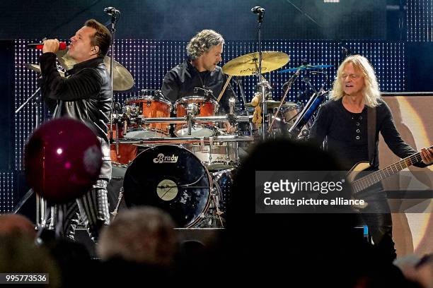 Singer Claudius Dreilich and bassist Christian Liebig of the rock band Karat perform on stage at the citizens' festival on the occasion of the German...