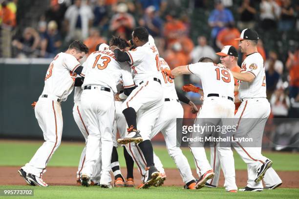 The Baltimore Orioles celebrates a Jonathan Schoop of the Baltimore Orioles walk off hit in the ninth inning during a baseball game against the New...