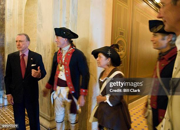Sen. Arlen Specter, R-Pa., stops to talk and pose for photos with members of America's March to Yorktown on the first floor of the Capitol on...