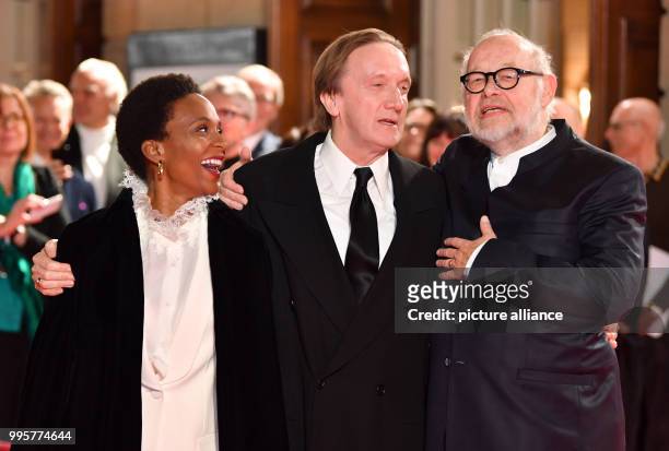 Musician Marius Mueller-Westernhagen and his wife Lindiwe Suttle are greeted by the director Juergen Flimm and Matthias Schulz at the reopening of...