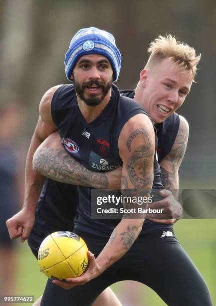 Jeff Garlett of the Demons is tackled by James Harmes of the Demons during a Melbourne Demons AFL training session at Gosch's Paddock on July 11,...