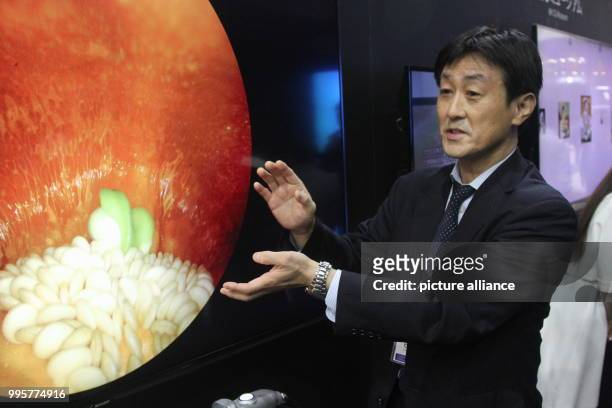 Juichi Hirata of the Japanese company Kairos Corp. Demonstrates an endoscopy with the help of a paprika which can be seen on a 8k screen from Sharp...
