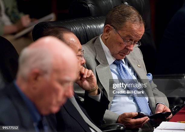 Sen. Ted Stevens, R-Alaska, reads two blackberry devices during the Senate Appropriations Committee Defense Subcommittee hearing on the FY2008...