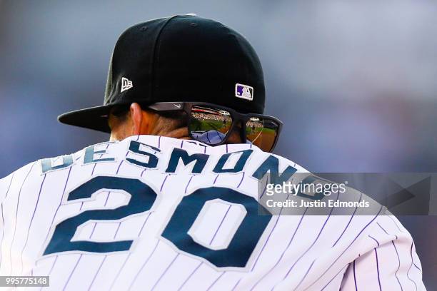 The stands are reflected in the glasses of Ian Desmond of the Colorado Rockies during the third inning against the Arizona Diamondbacks at Coors...