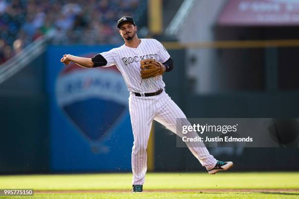 Third baseman Nolan Arenado of the Colorado Rockies throws to first base on the run for an out in the second inning against the Arizona Diamondbacks...