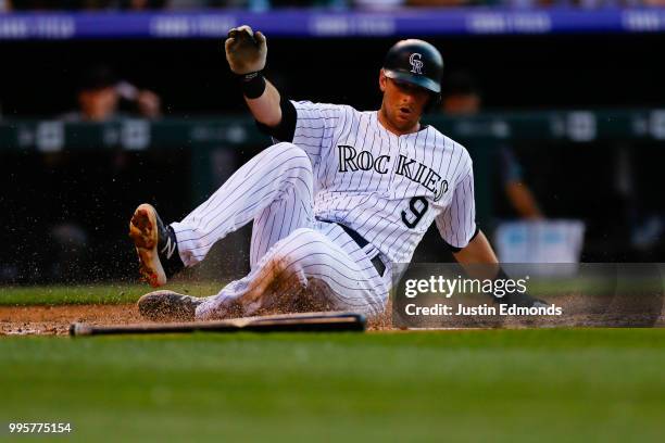 LeMahieu of the Colorado Rockies slides in to score during the third inning against the Arizona Diamondbacks at Coors Field on July 10, 2018 in...