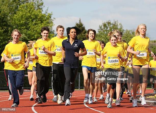 Kelly Holmes takes a warm up lap around the track with the athletes during the Aviva sponsored mentoring day for young athletes at Loughborough...
