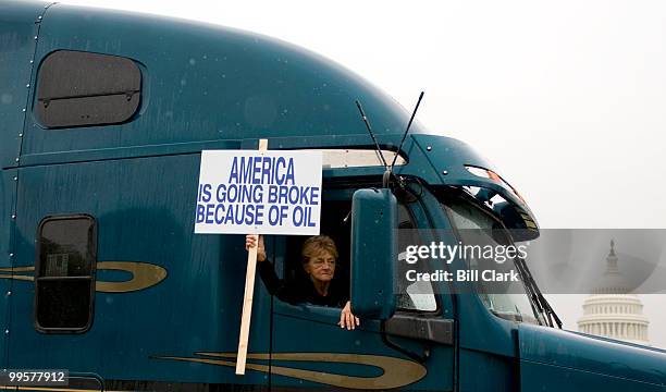 Convoy of trucks with their horns blaring drives down Third Street in fornt of the Capitol as they circle the National Mall to draw attention to...