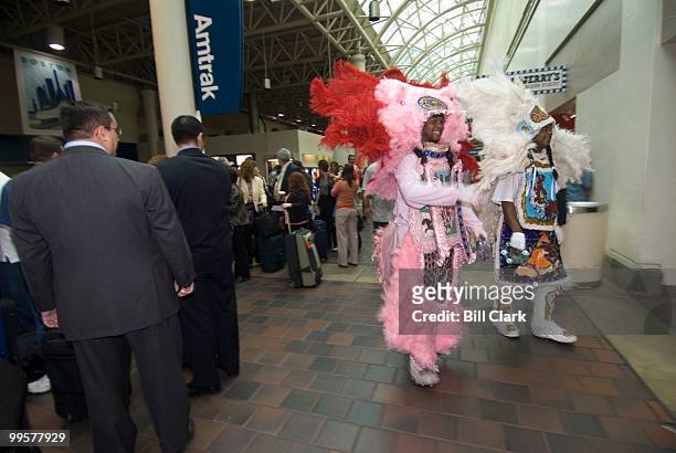 The Wild Magnolias Mardi Gras Indians lead the procession of artists, musicians and dancers through Union Station after they arrived on Amtrak's...